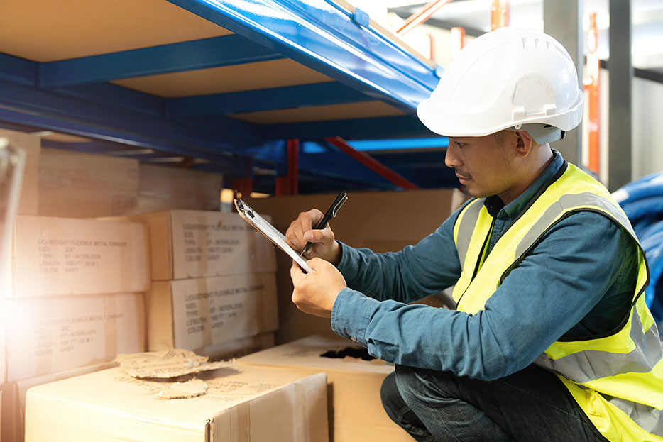 Worker reporting damaged goods in customs checks